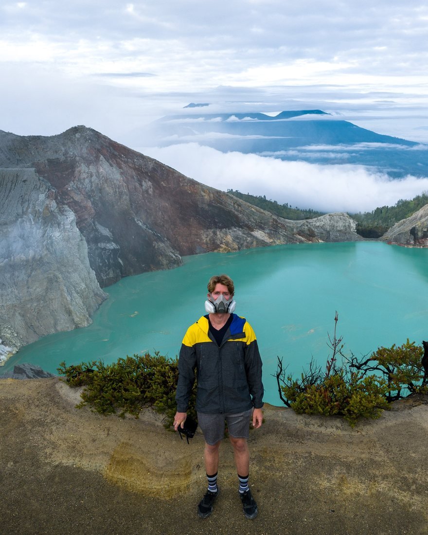 Brandon standing above a turquoise crater lake