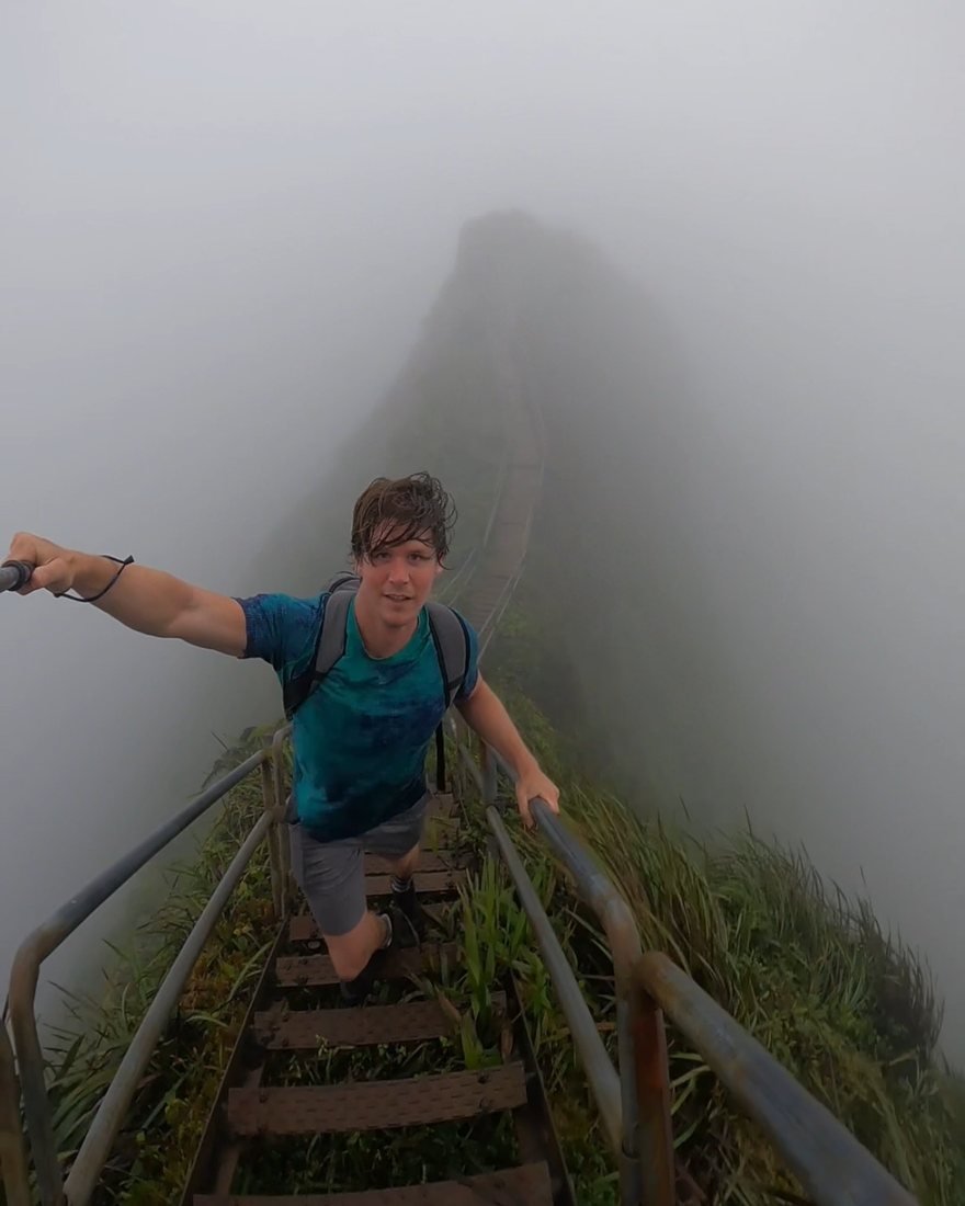 Brandon climbing a misty ridgeline staircase
